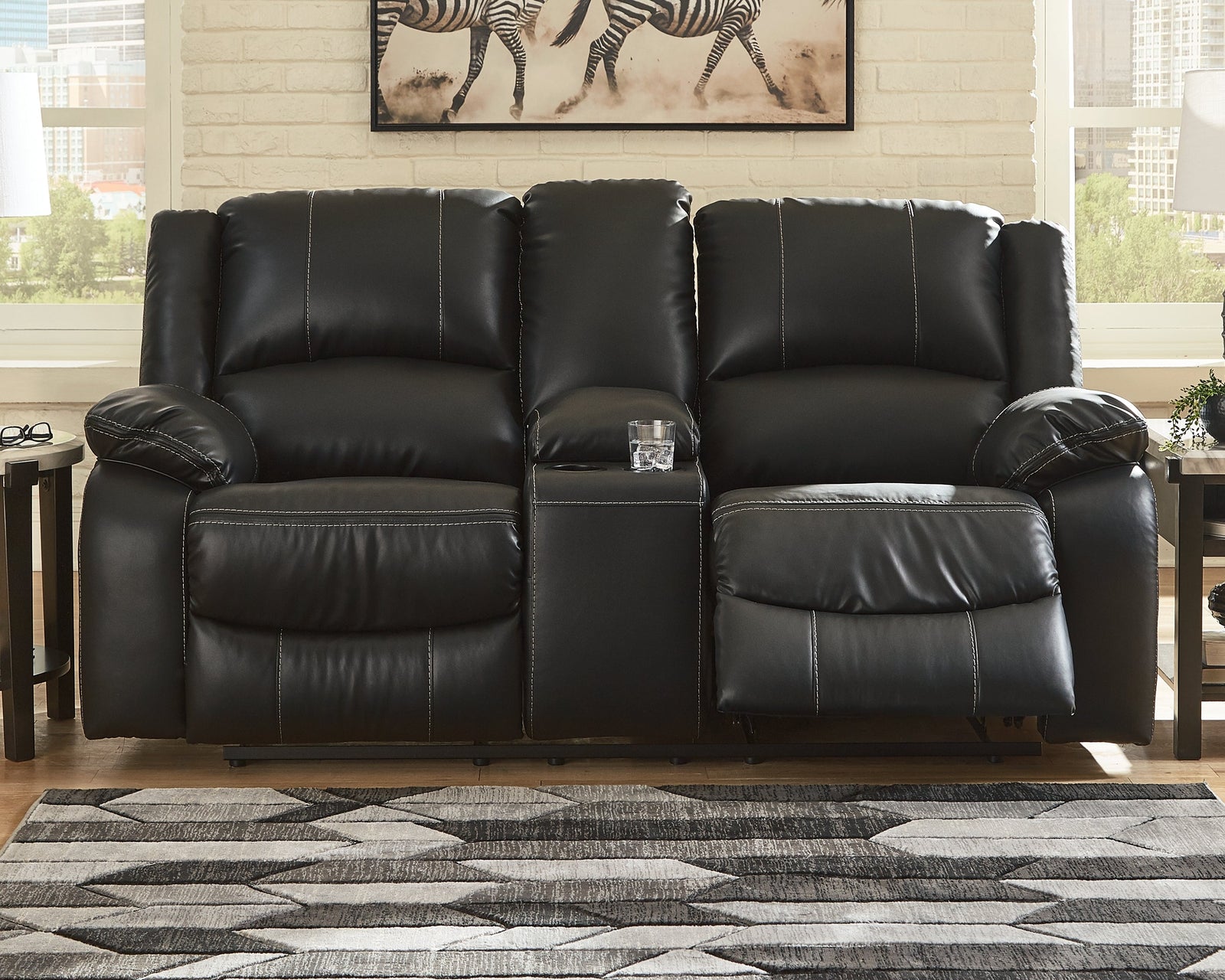 Calderwell Black Faux Leather Reclining Loveseat With Console